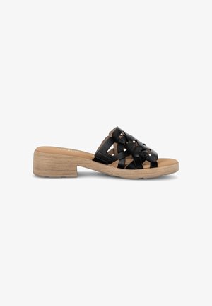 Black leather slide sandal with woven straps, low wooden block heel, and tan cushioned footbed.
