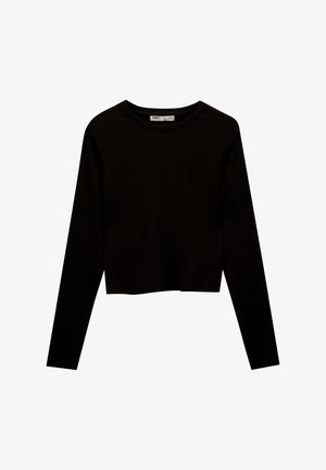 Haut noir coupé court à manches longues en tissu doux et extensible. Dispose d'un col rond et d'un design simple et minimaliste sans motifs.