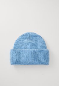 Blue knit beanie made of soft wool with a ribbed texture, featuring a folded cuff and a smooth crown.