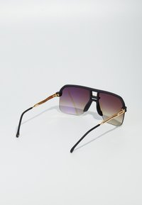 Ochelari de soare cu un cadru negru mat, lentile gradient purpurii și accente metalice în ton de aur. Formă rectangulară cu laterale groase și brațe din cauciuc.