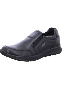 Schwarzer Leder-Schlüpfschuh mit elastischen Seitenteilen, abgerundeter Zehenpartie und strukturiertem Gummisohle. Verfügt über Nähte und ein minimalistisches Design.