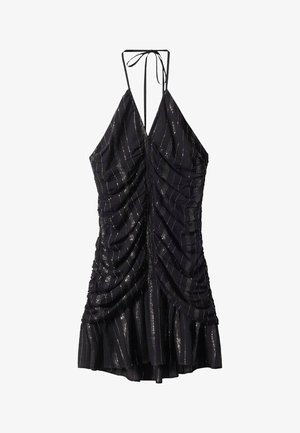 Robe noire à dos nu avec des détails froncés, présentant des rayures horizontales argentées et un ourlet évasé. Bretelles réglables au niveau du décolleté.