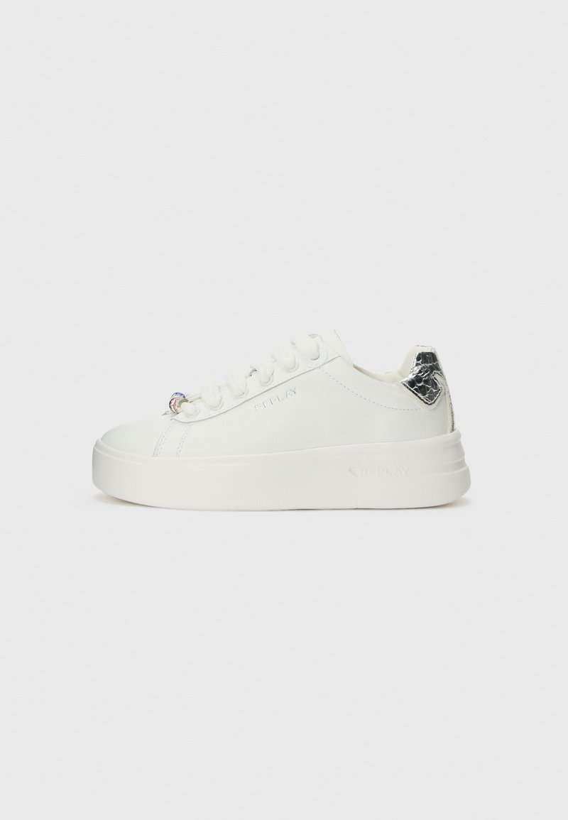 White sneakers with a sleek design, featuring a textured silver accent on the heel and a platform sole. Laced closure with decorative hardware.