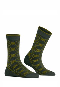 Grüne Baumwollsocken mit einem strukturierten Muster, das gelbe Blumenmuster und einen kontrastierenden gerippten Bund aufweist. Mittlere Länge bis zur Wade.