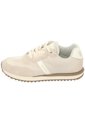 Beige athletic shoe featuring a mix of smooth and suede leather, round toe, lace-up front, cushioned collar, and textured rubber sole.