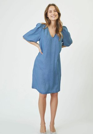 Denim dress with a V-neck, short puff sleeves, and a straight cut. Features a light blue color and subtle stitching details.