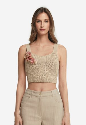Beige gestricktes Crop-Top mit breiten Trägern und floralen Akzenten, das über ein strukturiertes Muster und einen gerippten Halsausschnitt verfügt.