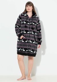 Accappatoio con cappuccio a righe bianche e nere, con motivo di renne e fiocchi di neve, dotato di chiusura con zip e tasche frontali, realizzato in morbido materiale in pile.
