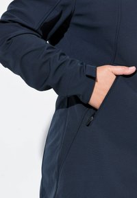 Tummansiniinen takki, jossa on sileä pinta, sivussa vetoketjullinen tasku ja mukavuuteen suunnitellut kapeat hihat.