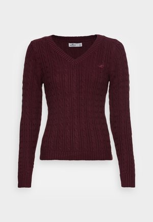 Damski ciemnogranatowy sweter z długim rękawem, warkoczowym splotem, dekoltem w serek i ściągaczami na rękawach, z małym haftowanym logo na lewej piersi.