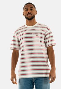 Striped short-sleeve t-shirt in white, featuring red and blue stripes. Includes a logo patch on the chest and a ribbed crew neckline.