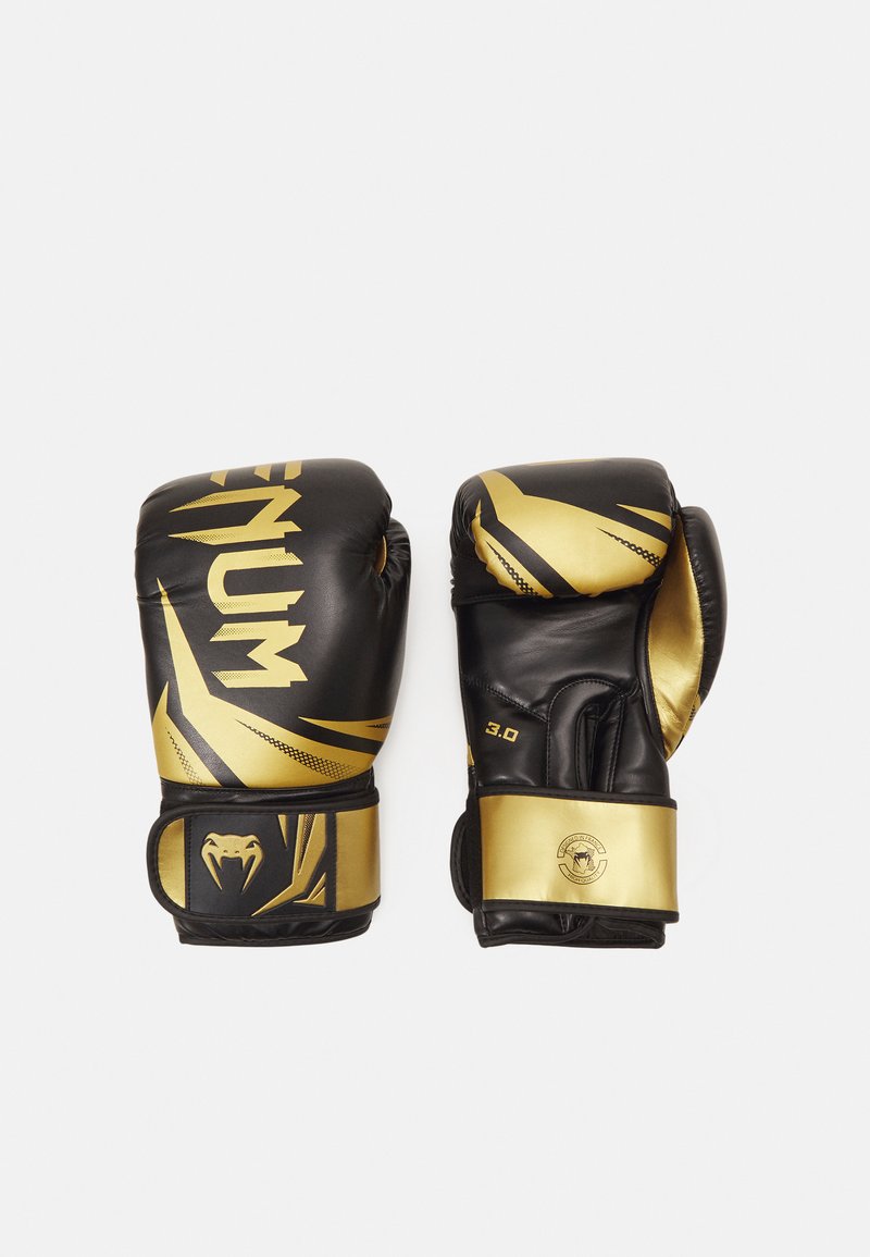 Black and gold boxing gloves made of synthetic leather, featuring a sleek design, bold graphics, and a secure wrist strap for support.