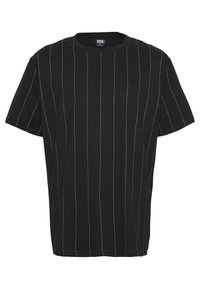 T-shirt noir avec des rayures verticales blanches, à manches courtes, un col rond et une coupe décontractée. Fabriqué en coton.