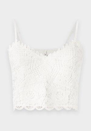 Bralette blanco de encaje con delicados patrones florales, bordes festoneados y tirantes ajustables. Textura suave con un detallado intrincado en toda la prenda.