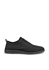Chaussure basse noire en suède lacée avec semelle épaisse segmentée et languette au talon.