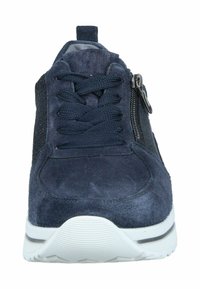 Navy suede sneaker with lace-up and zip closure, featuring textured sides and a white rubber sole with grooves for traction.