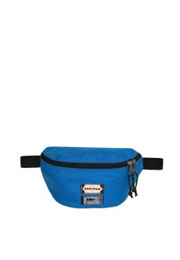 Borsa a vita in tessuto blu con cerniera nera e tracolla, caratterizzata da due patch con logo sul davanti. Texture liscia e forma arrotondata.