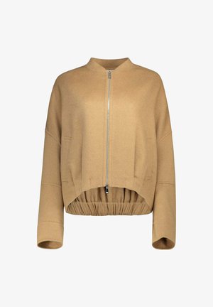 Giacca beige corta con maniche lunghe, zip frontale, orlo alto-basso e vita elasticizzata.