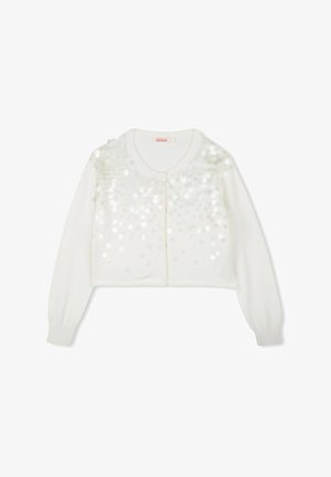 Cardigan blanc court à manches longues, avec un col rond et un design en sequins sur le devant. Texture tricot douce, fermeture à boutons.