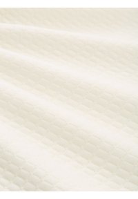 Wit gewatteerde stof met een diamanten patroon, gladde textuur en subtiele glans. Zacht, lichtgewicht materiaal geschikt voor diverse toepassingen.