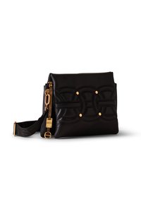 Black leather handbag with stitched circular patterns, gold rivets, and a detachable black strap with gold hardware on a white background.