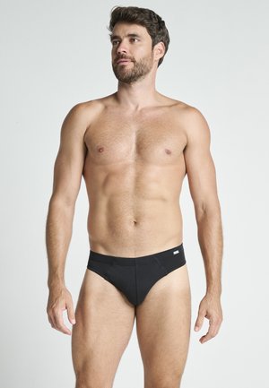 Schwarze Herrenunterhosen aus weichem Stoff, mit nahtlosem Design und einem Logo-Tag am Bund. Standardpassform mit moderatem Sitz.