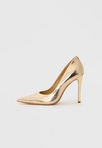 Shiny gold pointed-toe high heel shoe with a slim stiletto heel on a plain light background.