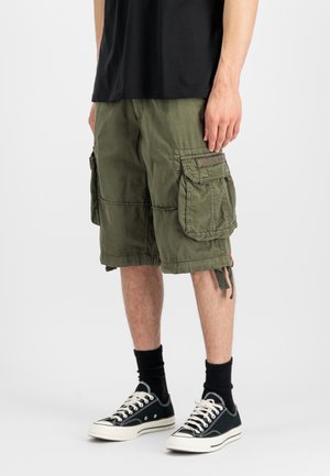 Cargo shorts in olive green cotton blend with multiple large pockets, adjustable drawstrings at the hem, and tonal stitching details.