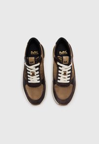 Brown and tan sneakers with a mesh and suede upper, white laces, circular accents, and a gold logo on the tongue.