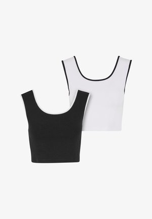 To sømløse crop tops, en sort og en hvid, begge med en rund halsudskæring og kontrastkanter i henholdsvis sort og hvid.