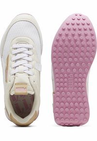 White and beige sneaker with pink accents. Features mesh and synthetic upper, round toe, flat laces, and textured rubber sole with circular patterns.