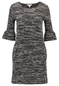 Robe en maille noir et blanc avec manches cloche trois-quarts, col rond et motif texturé. Mi-longue avec poches latérales.