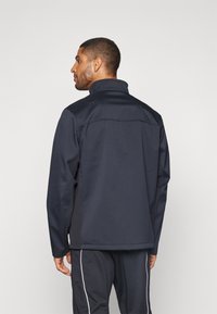 Under Armour SHIELD JACKET - Softshell-jope - black/white
