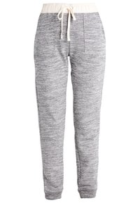 Grå sweatshirtbyxor i strukturerat material, elastisk midja med dragsko, och två framfickor. Taperad bendesign för en figurnära look.