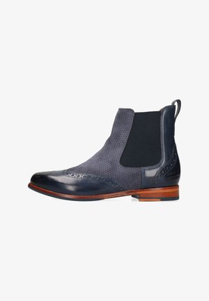 Botte Chelsea en cuir bleu marine et daim avec perforations brogues, panneau latéral élastique, semelle en cuir et languette de traction à l'arrière.