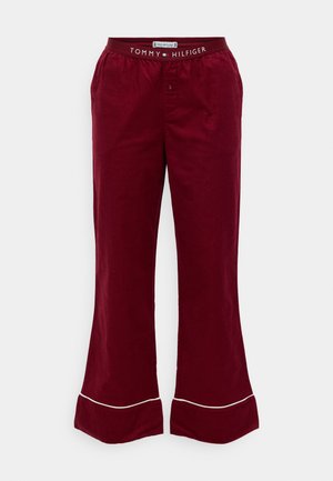 Bordó bavlněné kalhoty do zvonu s červeným pasem, na kterém je logo "TOMMY HILFIGER", a bílým lemem na spodním okraji. Design s plochým předním dílem.