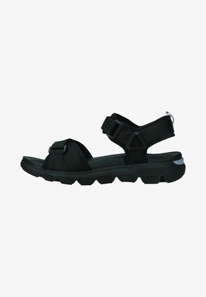 Black synthetic sandals with adjustable straps, textured footbed, and a treaded rubber sole for grip and stability.