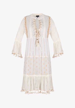 White dress with a round neckline, ruffled front, and tassel accents. Features lace trim and polka dot patterns, with bell sleeves.