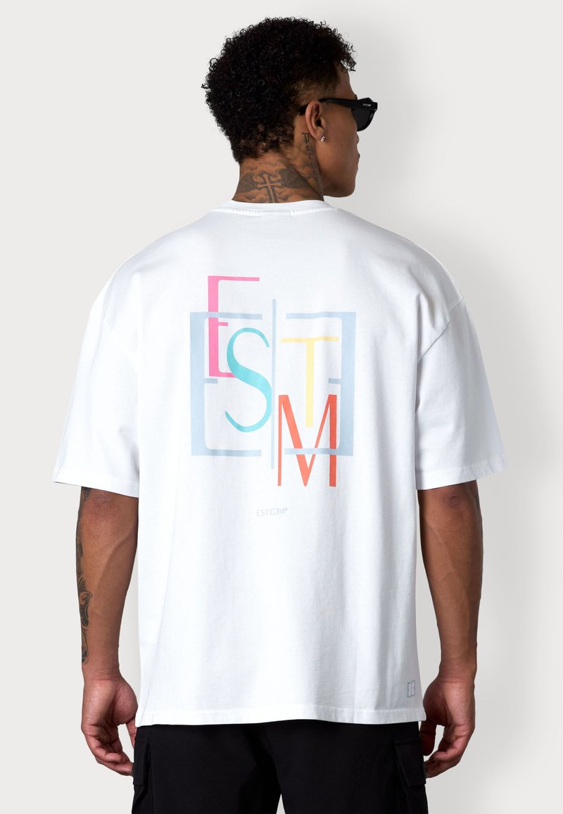 White cotton t-shirt with short sleeves, featuring a multicolored geometric logo design on the back. Crew neck and relaxed fit.