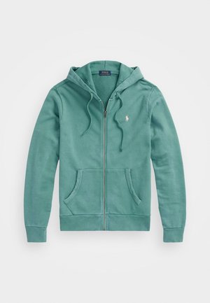 Felpa verde in cotone con zip, cappuccio regolabile, tasche frontali e un piccolo logo ricamato sul lato sinistro del petto. Texture morbida.
