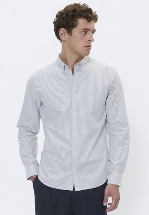 Striped button-down shirt in light blue and white cotton, featuring a collar and single cuffs. Textured fabric with vertical stripes.