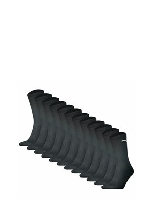 Zehn Paar schwarze Knöchelsocken, in einer Reihe angeordnet, jedes mit einem kleinen weißen Logo nahe dem oberen Bündchen.