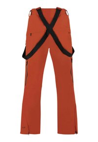 Oranga skidbyxor med justerbara svarta hängslen. Har två sidofickor med dragkedja och dragkedjor vid anklarna för enkel på- och avtagning.