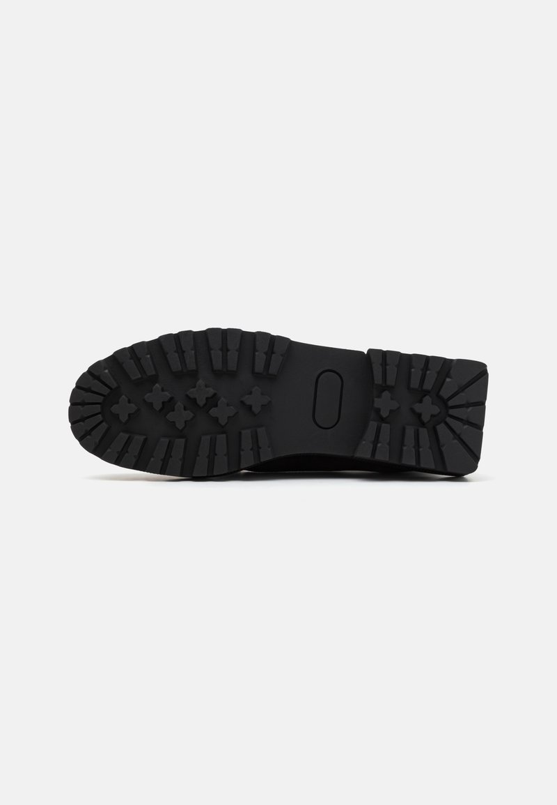 Semelle de chaussure en caoutchouc noir avec un design de semelle rugged. Caractéristiques de rainures profondes et de motifs croisés pour l'adhérence. Plate et large avec des bords arrondis.