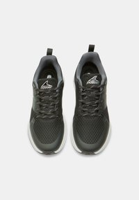 Black athletic shoes with mesh fabric upper, grey accents, rounded toe, and white rubber sole. Features shoelaces and pull tab for easy wear.