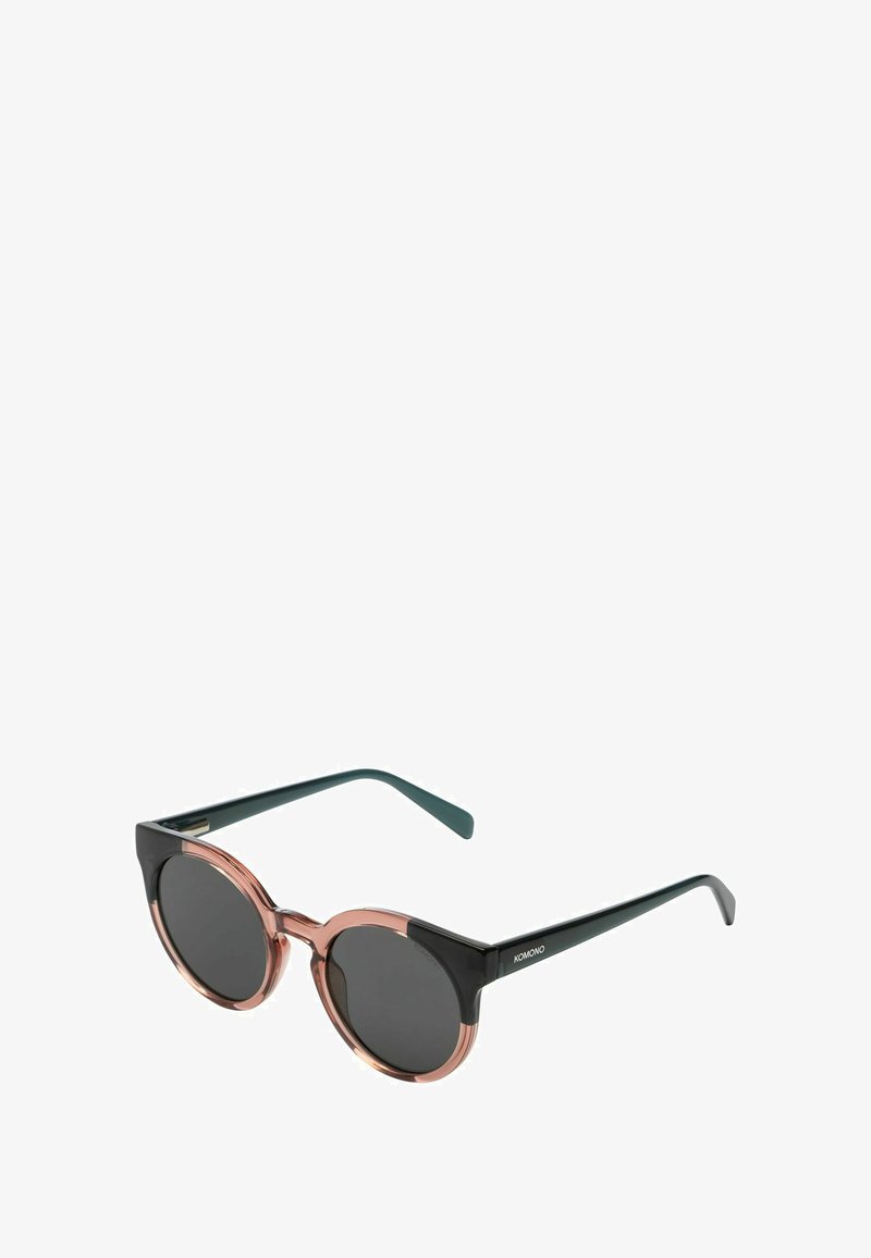 Lunettes de soleil rondes avec une monture supérieure noire et une monture inférieure rose. Verres foncés, dotées de branches vertes élégantes. Design minimaliste avec une finition brillante.