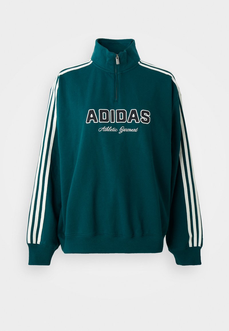 Sweatshirt teal avec col montant, logo Adidas blanc et texte "Vêtement de sport" ; présente des accents à trois bandes blanches sur les manches.
