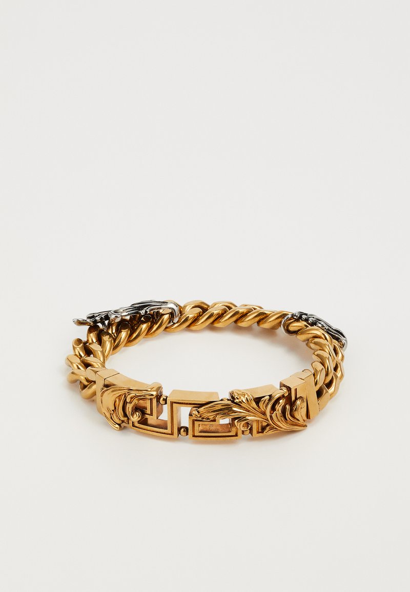 Armband aus goldfarbigem Metall mit verdrehten Gliedern, die mit rechteckigen und blattförmigen Akzenten in polierten Oberflächen und silbernen Highlights durchsetzt sind.