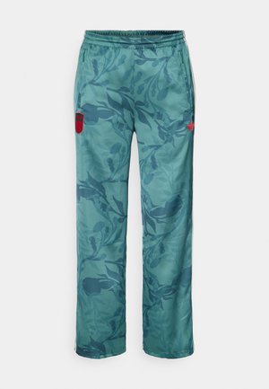 Light teal trousers featuring a floral pattern, elastic waistband, and side pockets. Red logo accent on the left thigh adds detail.