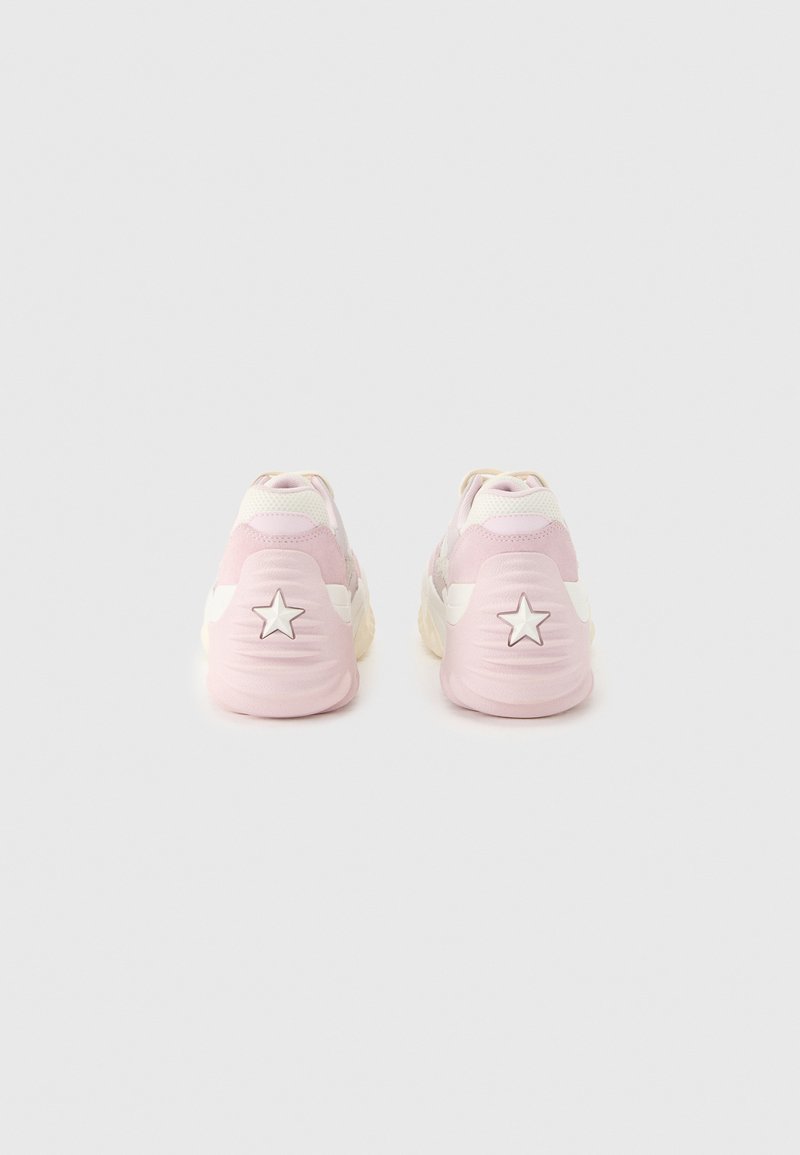Pair of light pink and white sneakers viewed from the back, each heel featuring a raised white star design.